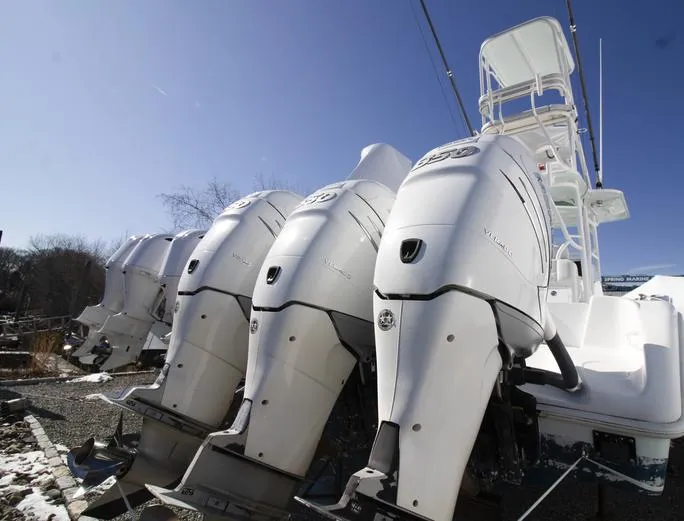Slide: The Image of 2018 Yellowfin 36 boats with powerful outboard engines, lined up under clear blue sky. - 6