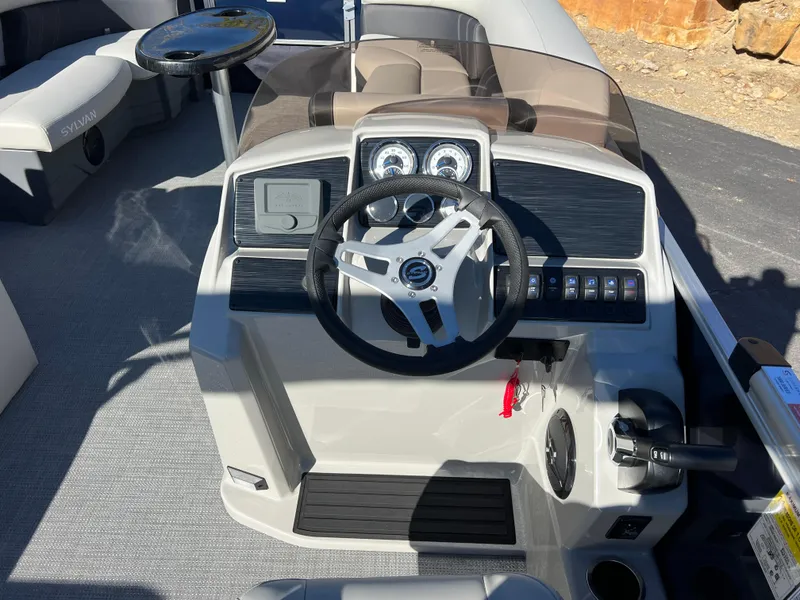 Slide: The Image of 2025 Sylvan Mirage Fish 8522 Party Fish boat dashboard with steering wheel and controls. - 29