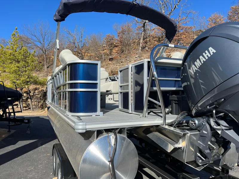 Slide: The Image of 2025 Sylvan Mirage Fish 8522 Party Fish pontoon boat with Yamaha engine, docked outdoors. - 8