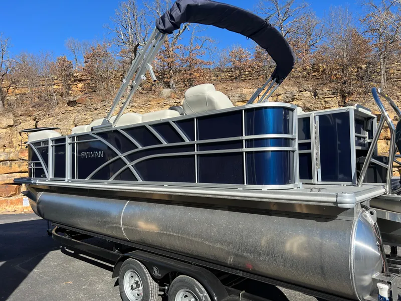 Slide: The Image of 2025 Sylvan Mirage Fish 8522 Party Fish pontoon boat on trailer, outdoors. - 9