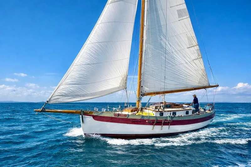 The Image of Sailing a 1982 Bristol Channel Cutter 28 on open sea under clear blue skies. - 0