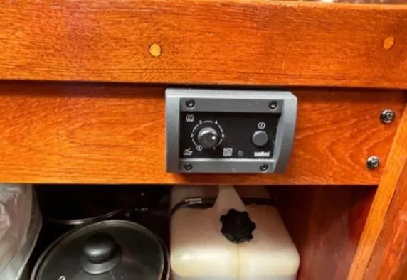 Slide: The Image of Cozy 1982 Bristol Channel Cutter 28 interior with wood paneling, portholes, and nautical decor. - 16