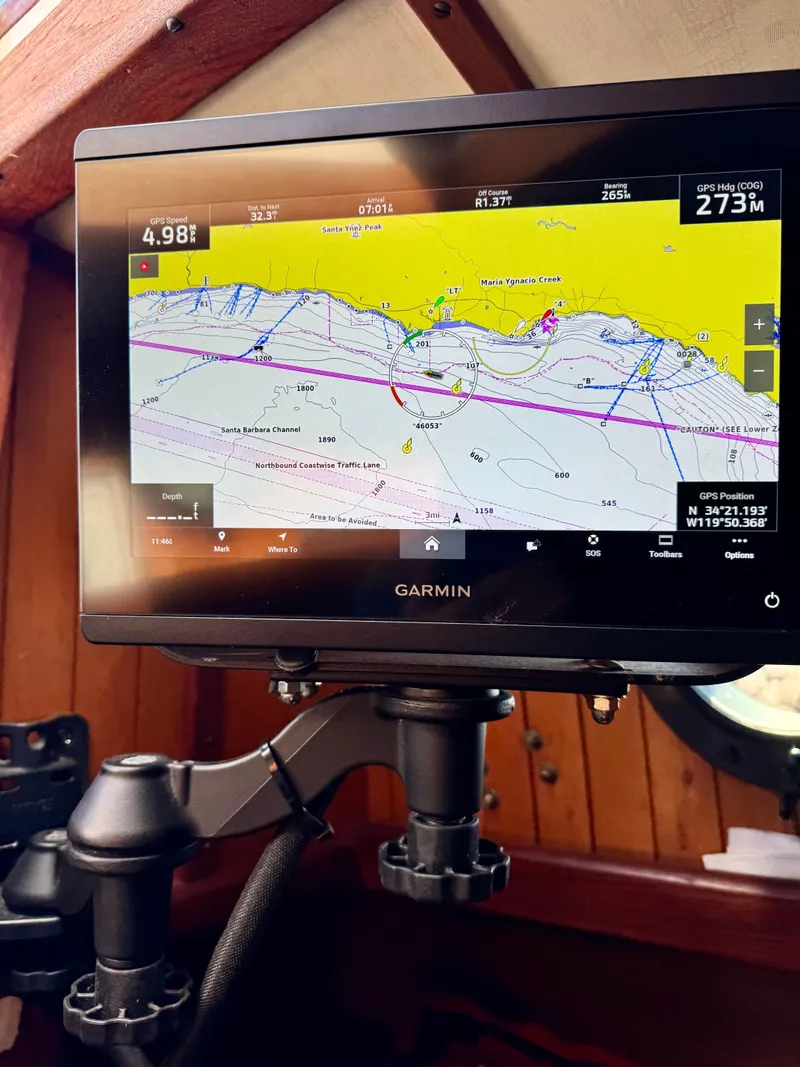 Slide: The Image of Interior of 1982 Bristol Channel Cutter 28, featuring cozy wooden cabin with seating and decor. - 6