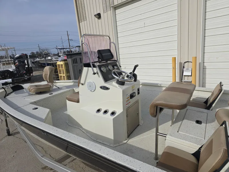 Slide: The Image of 2019 Xpress H20B boat with center console and seating, parked near a building. - 10