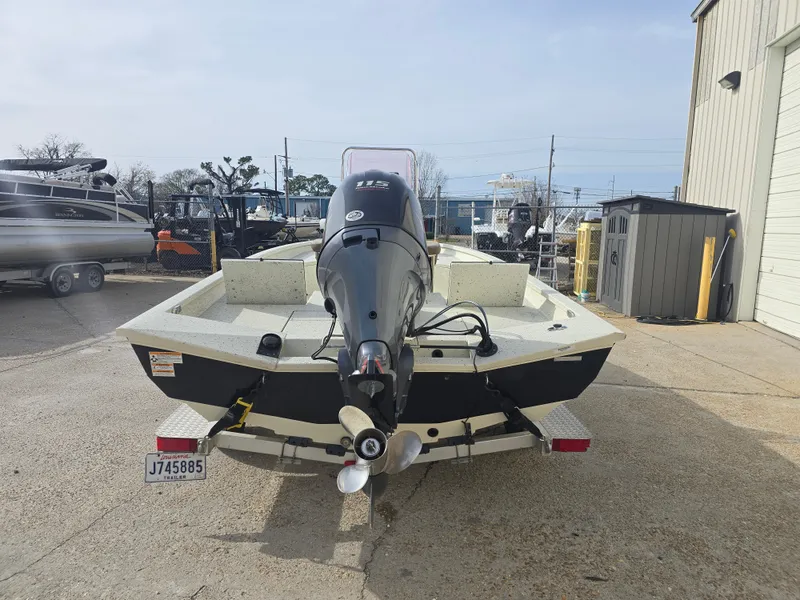 Slide: The Image of 2019 Xpress H20B boat with outboard motor, parked outdoors. - 4