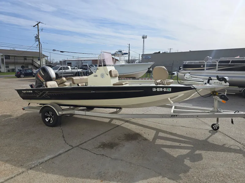 Slide: The Image of 2019 Xpress H20B boat on trailer in parking lot, side view. - 6