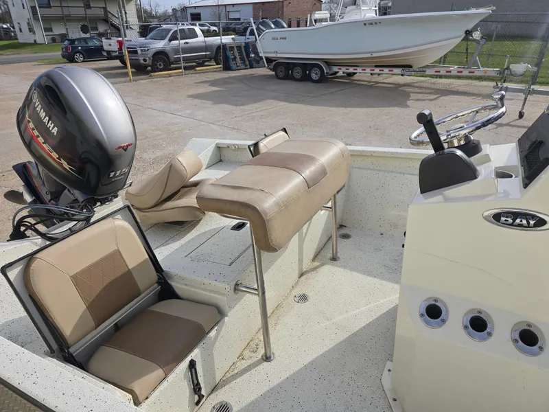 Slide: The Image of 2019 Xpress H20B boat interior with Yamaha outboard motor, featuring beige seating and steering console. - 8