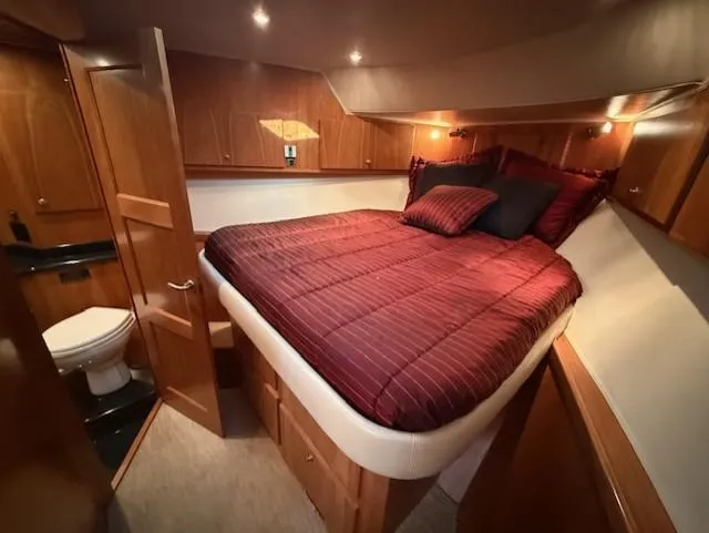 Slide: The Image of Luxurious 2007 Navigator 51 yacht bedroom with elegant red bedding and modern decor. - 10