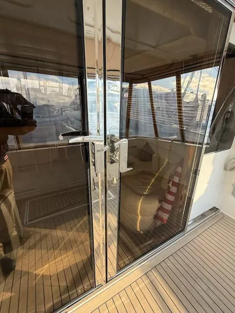 Slide: The Image of Interior of 2007 Navigator 51 yacht with wood paneling and built-in storage. - 13