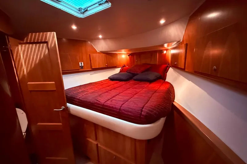 Slide: The Image of Luxurious 2007 Navigator 51 yacht cabin with cozy bed and elegant wood finish. - 16