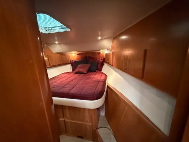 Slide: The Image of Luxurious cabin interior of 2007 Navigator 51 yacht with cozy bed and wooden finish. - 17