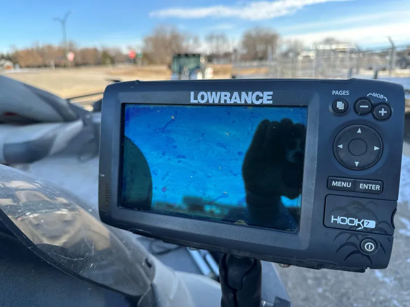 Slide: The Image of Lowrance fish finder on 2011 Tracker Super Guide V16 boat, outdoor setting. - 10