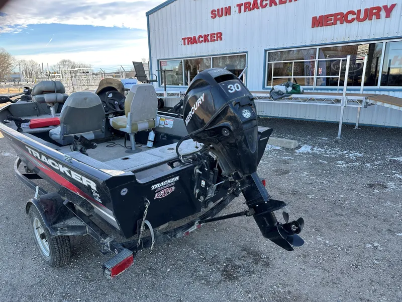 Slide: The Image of 2011 Tracker Super Guide V16 boat with Mercury 30 engine, parked outside dealership. - 3