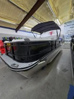 The Image of 2025 G3 322rc pontoon boat in showroom with canopy and modern design. - 1
