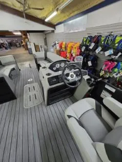 Slide: The Image of Interior of 2025 G3 322rc boat with steering wheel and seating, displayed in showroom. - 6