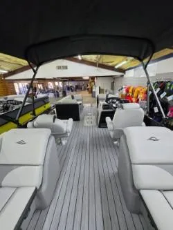 Slide: The Image of 2025 G3 322rc boat interior with seating and canopy in showroom. - 7