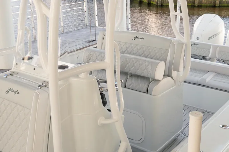 Slide: The Image of 2023 Yellowfin 26 Hybrid boat interior with cushioned seating and sleek design. - 12