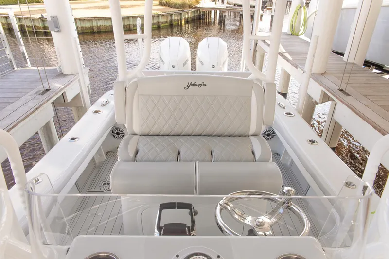 Slide: The Image of 2023 Yellowfin 26 Hybrid boat interior with luxurious seating and steering wheel. - 13