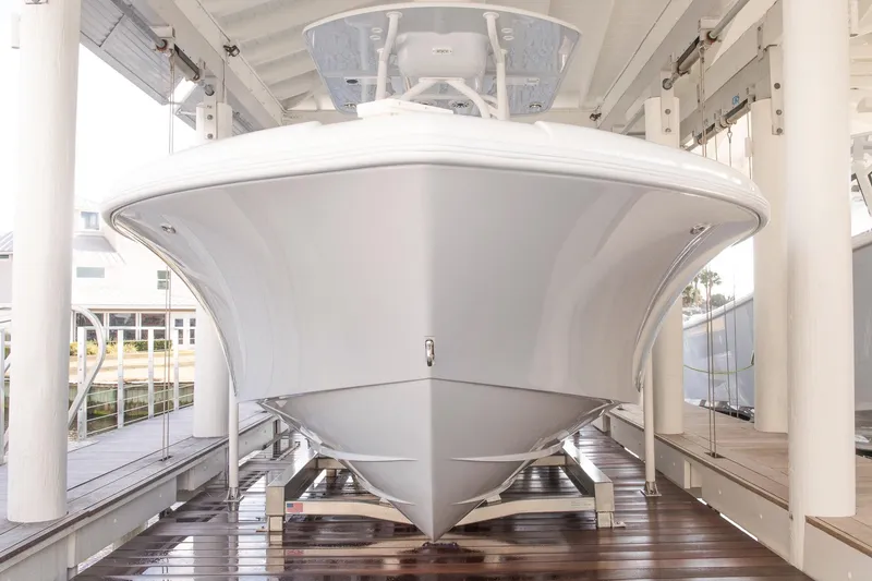 Slide: The Image of 2023 Yellowfin 26 Hybrid boat in a covered dock, front view. - 2