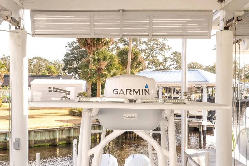 Slide: The Image of 2023 Yellowfin 26 Hybrid boat with Garmin equipment, docked near waterfront homes. - 22
