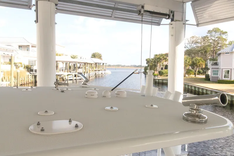 Slide: The Image of 2023 Yellowfin 26 Hybrid boat docked near waterfront homes. - 31