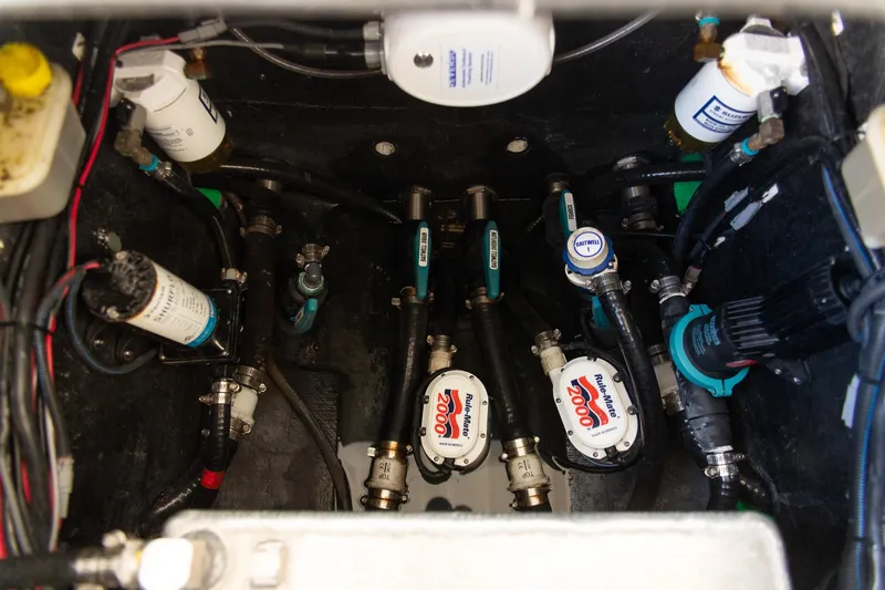 Slide: The Image of Engine compartment of 2023 Yellowfin 26 Hybrid boat, showcasing pumps and wiring. - 33