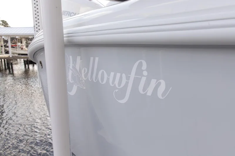 Slide: The Image of 2023 Yellowfin 26 Hybrid boat docked by the water. - 5