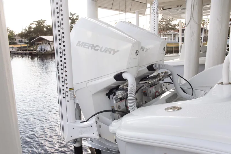 Slide: The Image of 2023 Yellowfin 26 Hybrid boat with dual Mercury outboard engines docked by the water. - 6