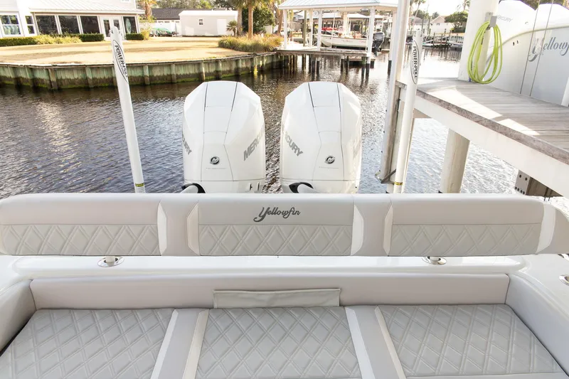 Slide: The Image of 2023 Yellowfin 26 Hybrid boat with dual Mercury engines docked by the water. - 7