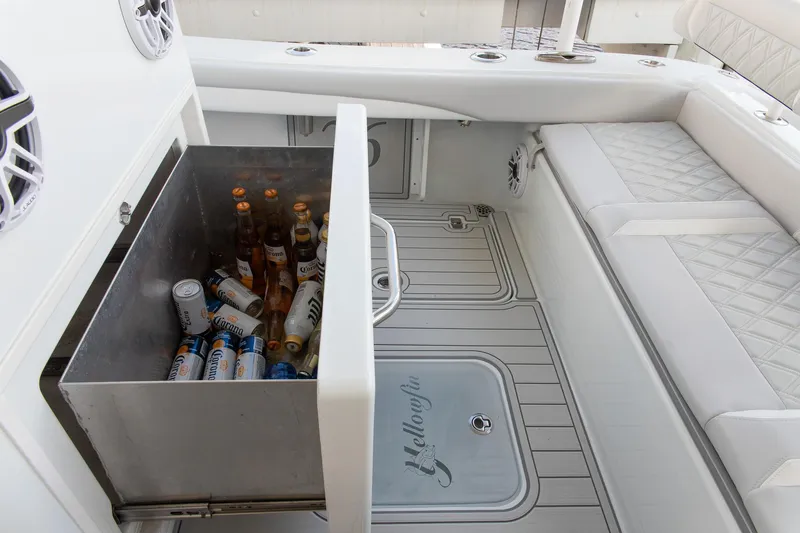 Slide: The Image of 2023 Yellowfin 26 Hybrid boat interior with built-in cooler and seating. - 9