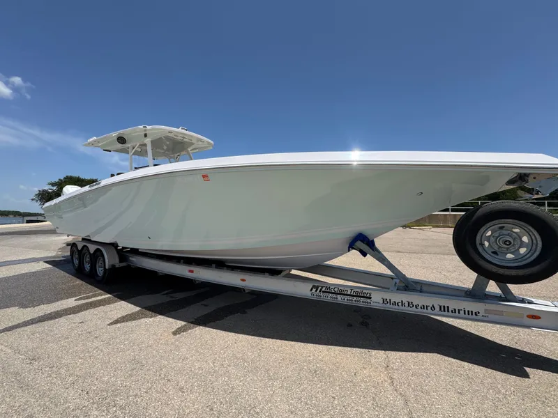 Slide: The Image of 2018 Fountain 38 CC boat on trailer under clear blue sky. - 0