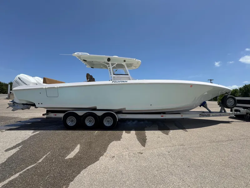 Slide: The Image of 2018 Fountain 38 CC boat on trailer under clear blue sky. - 1
