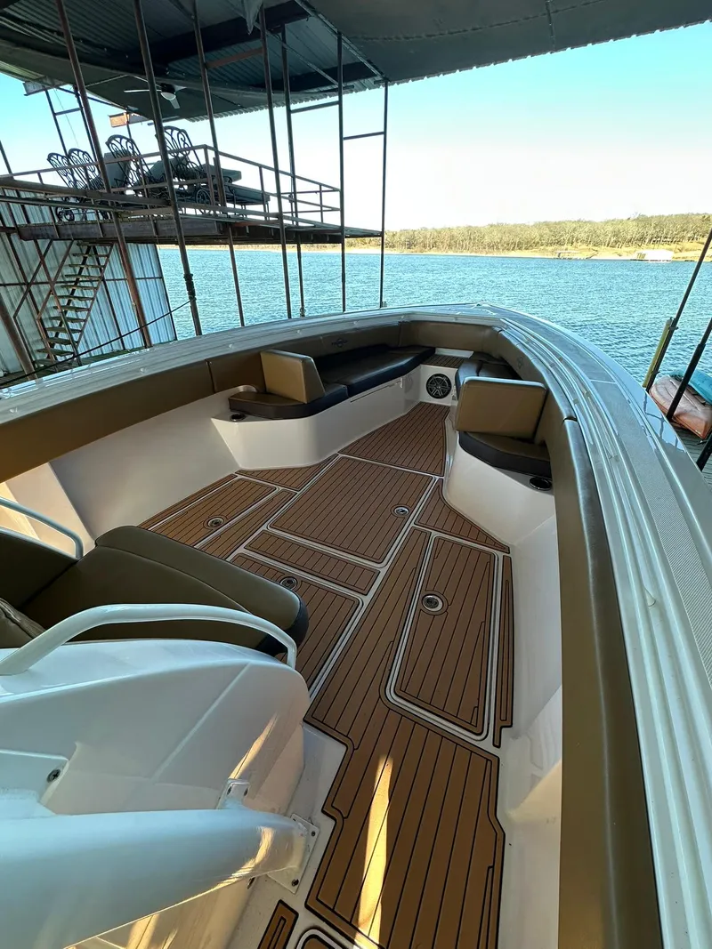 Slide: The Image of 2018 Fountain 38 CC boat with sleek deck design, docked by a serene lake. - 10