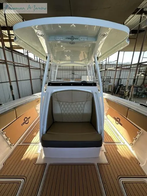 Slide: The Image of 2018 Fountain 38 CC boat interior with cushioned seating and wood-patterned flooring. - 15