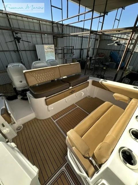 Slide: The Image of 2018 Fountain 38 CC boat interior with tan seating and wood flooring. - 20