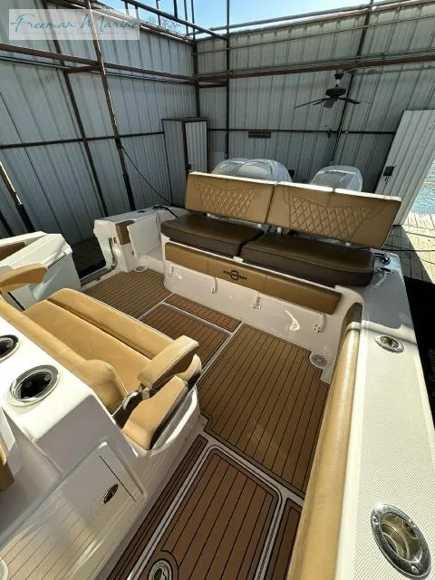 Slide: The Image of 2018 Fountain 38 CC boat interior with tan seating and wood-style flooring. - 21