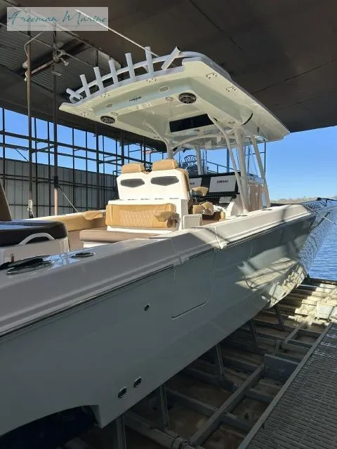 Slide: The Image of 2018 Fountain 38 CC boat docked in a marina, side view. - 22