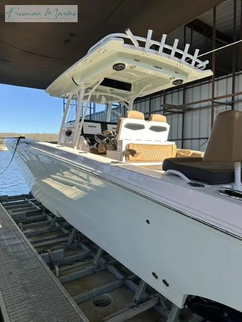 Slide: The Image of 2018 Fountain 38 CC boat docked in a marina, showcasing sleek design and modern features. - 24