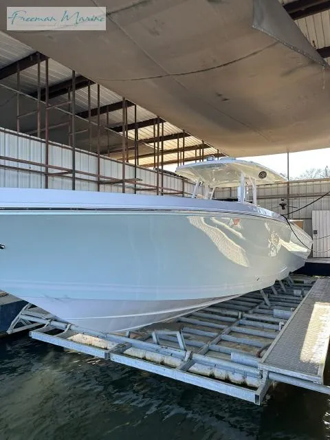 Slide: The Image of 2018 Fountain 38 CC boat in a covered dock, side view. - 25