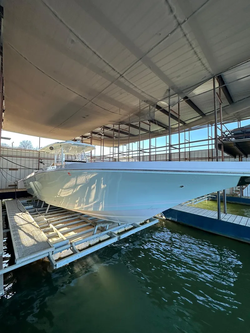 Slide: The Image of 2018 Fountain 38 CC boat docked in a covered marina. - 3