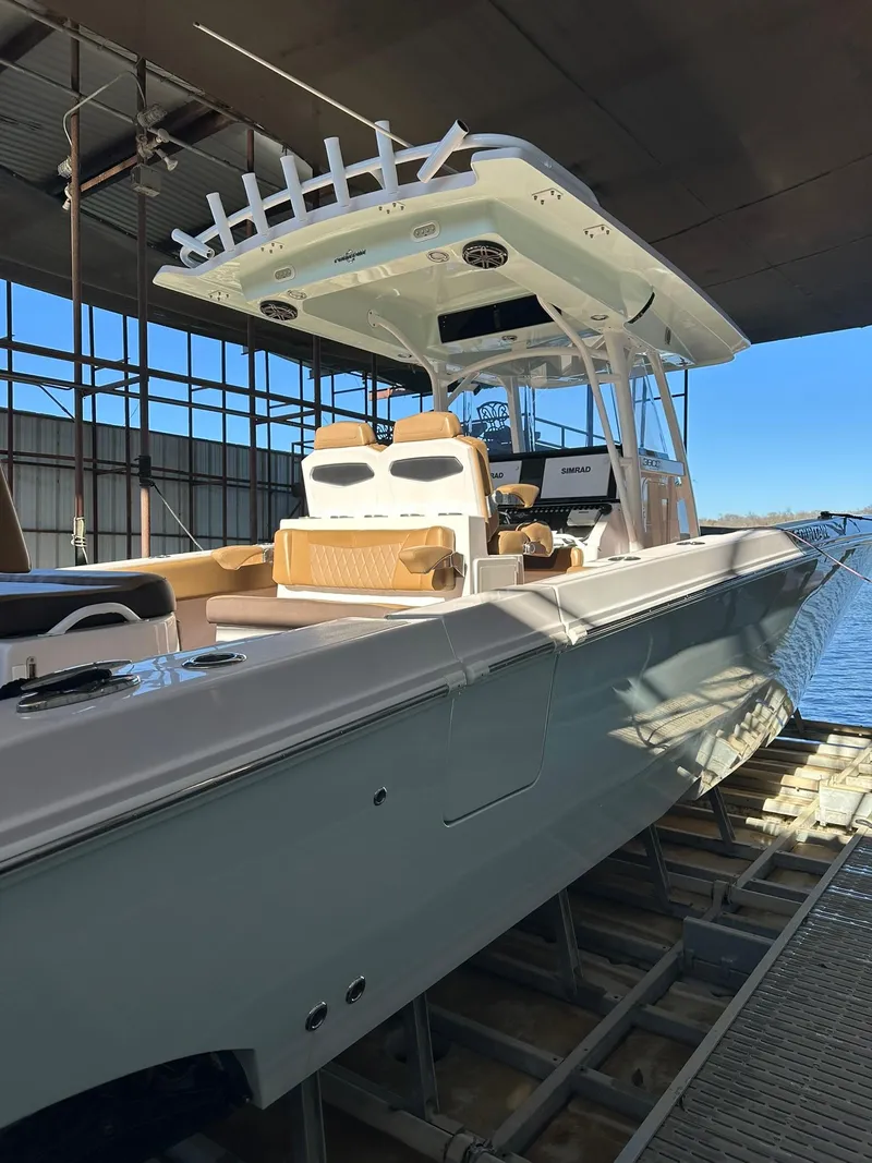 Slide: The Image of 2018 Fountain 38 CC boat docked in a covered marina. - 4