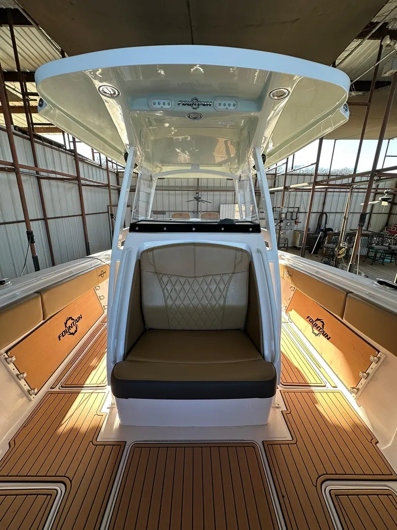 Slide: The Image of 2018 Fountain 38 CC boat interior with cushioned seating and teak flooring. - 7