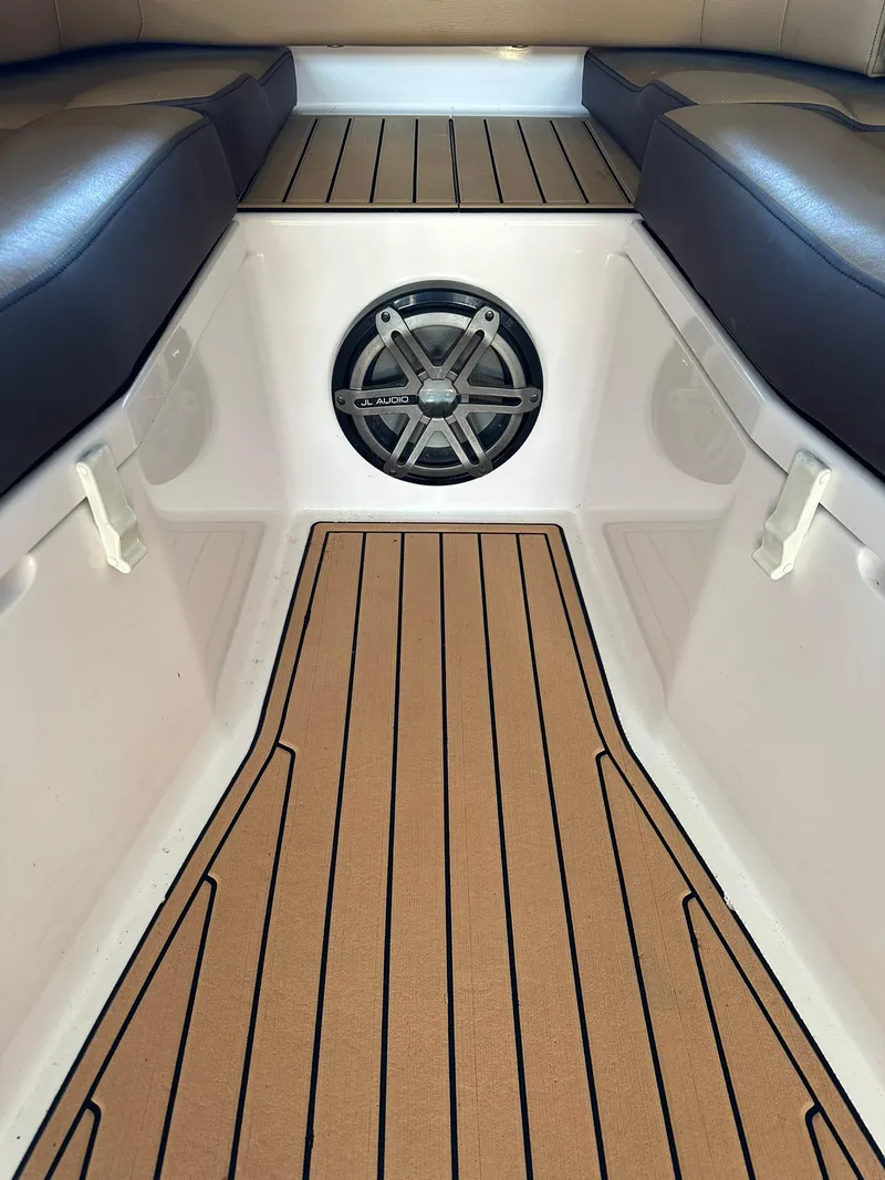 Slide: The Image of 2018 Fountain 38 CC boat interior with cushioned seating and speaker system. - 9