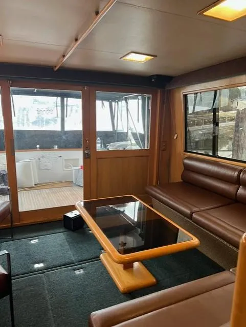 Slide: The Image of Interior of 1989 Ocean Alexander 42 yacht with leather seating and glass table. - 10