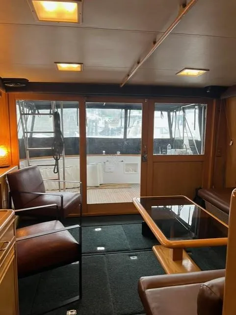 Slide: The Image of Interior of 1989 Ocean Alexander 42 yacht, featuring seating and a glass table. - 11