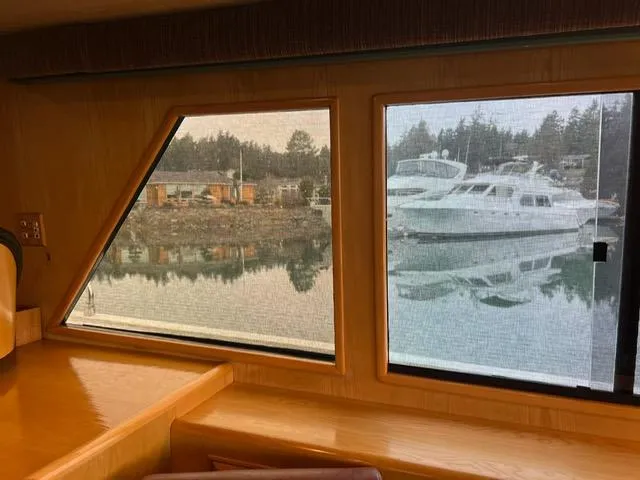 Slide: The Image of Interior view from 1989 Ocean Alexander 42 yacht, showcasing marina and boats through windows. - 14