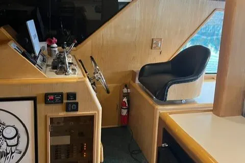 Slide: The Image of Interior helm of 1989 Ocean Alexander 42 yacht with steering wheel and captain's chair. - 17