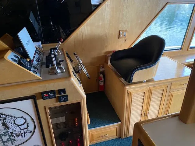 Slide: The Image of Helm station of 1989 Ocean Alexander 42 yacht with control panel and captain's chair. - 19
