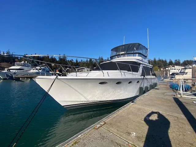 Slide: The Image of 1989 Ocean Alexander 42 yacht docked in a marina under clear blue skies. - 2
