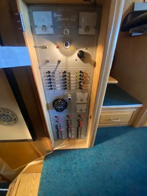 Slide: The Image of Electrical panel of a 1989 Ocean Alexander 42 yacht, featuring switches and gauges. - 25